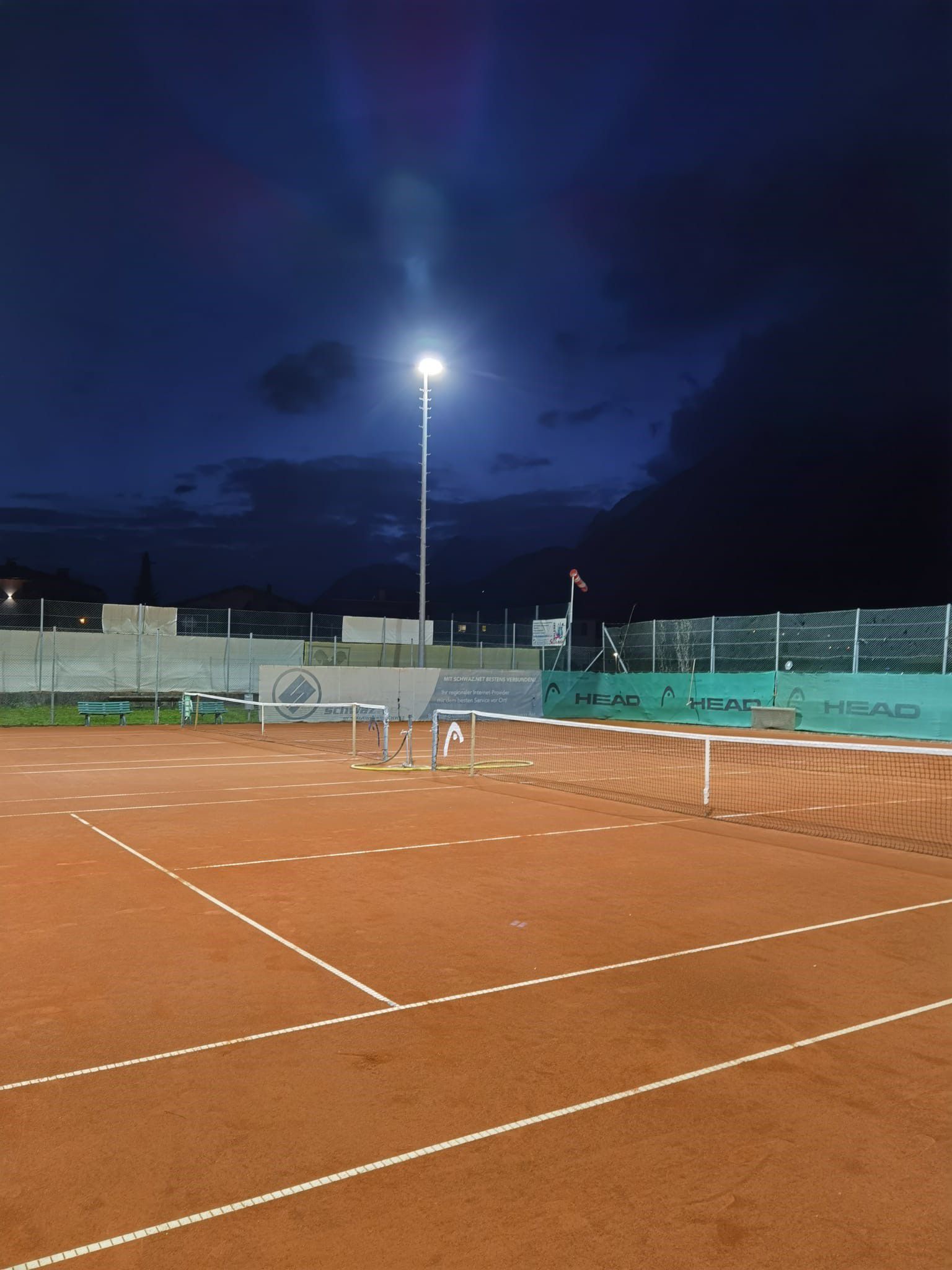 LED outdoor lighting of a tennis court with uniform illumination of the playing surface at night