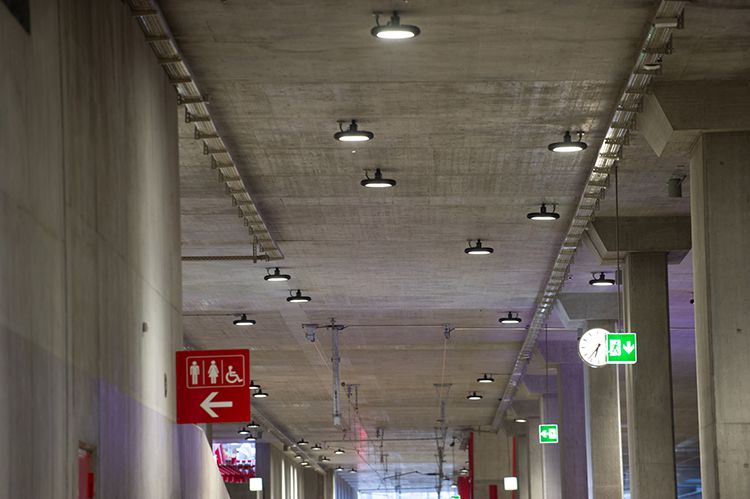 Illuminated station corridor with mounted LED ceiling spotlights - robust lighting for safe orientation in traffic areas