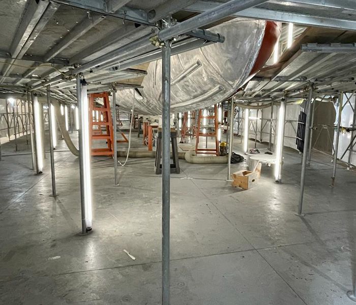 LED work light in a shipyard for maintenance work on the ship's hull - efficient lighting for shipping and industry