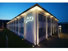 Facade lighting with GIFAS VisuLED - stylish and energy-efficient LED lighting on the Jura company building at night