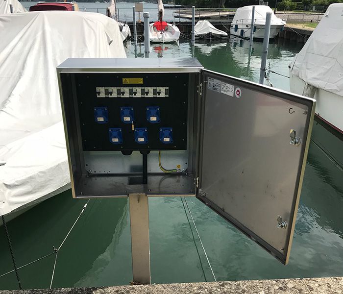 Power distributor in the harbor at the jetty for safe power supply for boats and yachts in shipping
