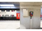 Power distributor and connection box from GIFAS in the station area in front of an SBB train - secure power supply for railroad infrastructure