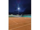 LED outdoor lighting of a tennis court with uniform illumination of the playing surface at night