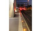 Active LED safety lighting on the platform edge at night with an incoming train at Wankdorf station