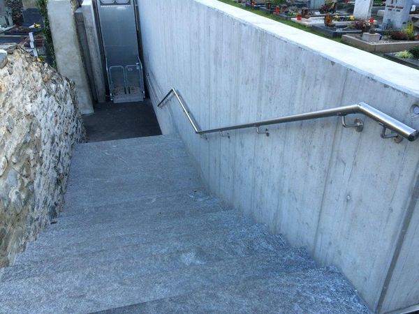 Staircase with stainless steel handrail and installed lighting at Glis cemetery