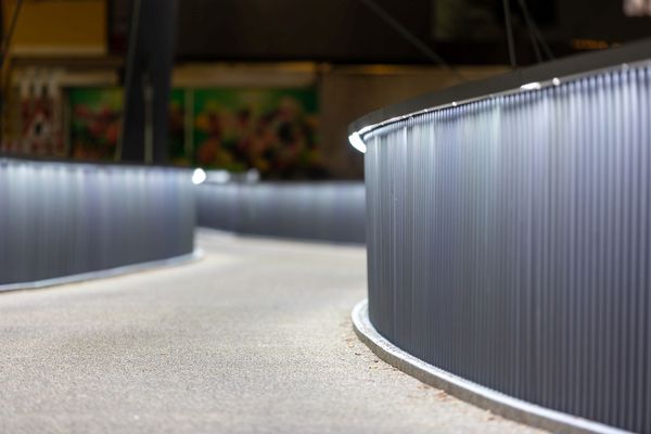 LaneLED batten luminaire along a curved railing structure provides homogeneous illumination and safe guidance on a bridge