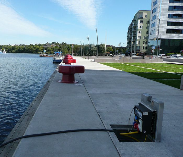 Underfloor power distributor on a waterfront promenade for supplying power to boats and infrastructure in the harbor area