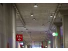Illuminated station corridor with mounted LED ceiling spotlights - robust lighting for safe orientation in traffic areas