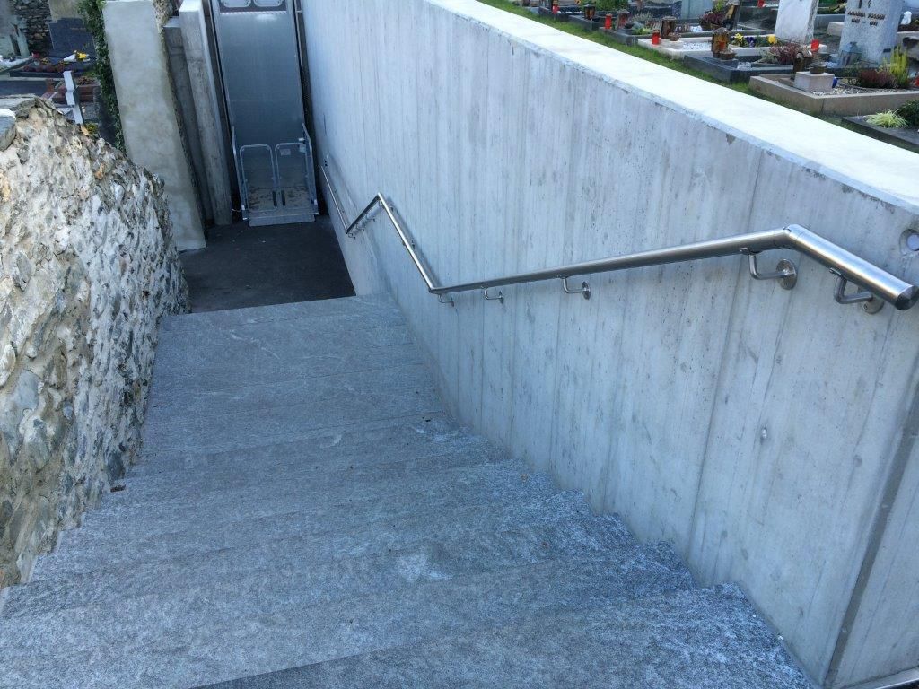 Staircase with stainless steel handrail and installed lighting at Glis cemetery