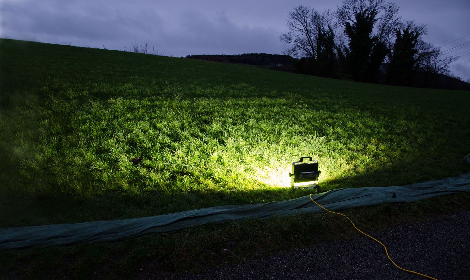 Mobile LED spotlight illuminates a field at dusk - used by the army, fire department or civil defense