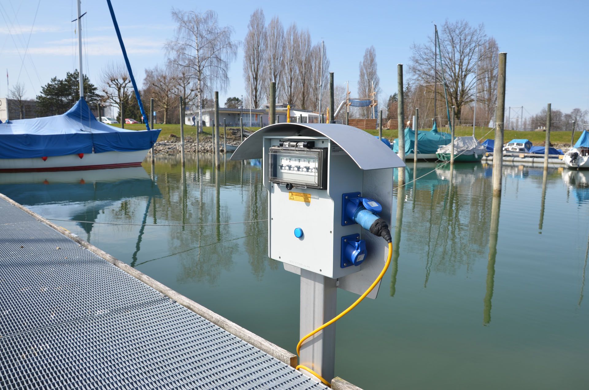 Energy column on a jetty in the harbor to supply power to boats - reliable solution for shipping