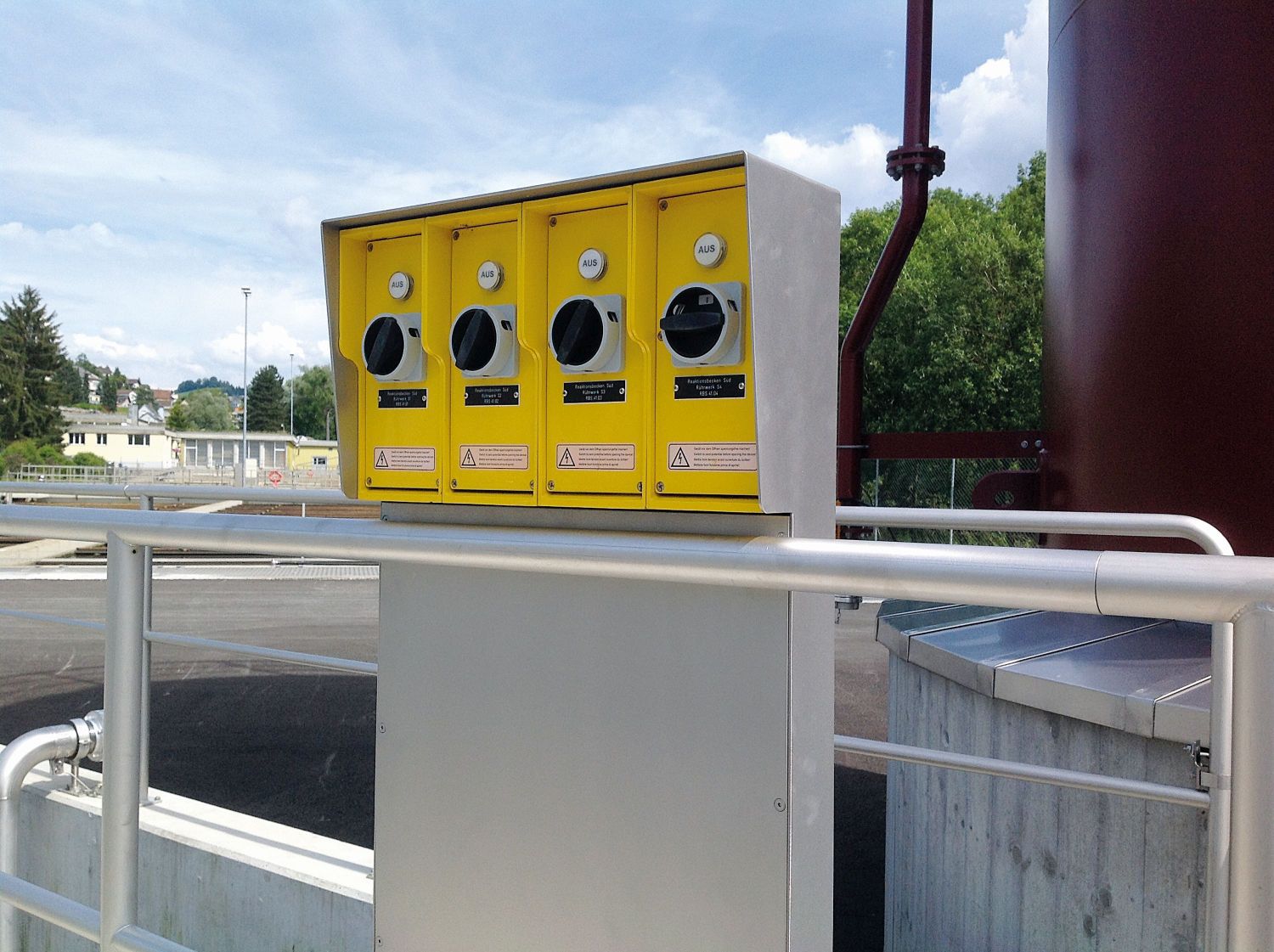 Stainless steel safety switch system with four yellow switches for safe power supply in a wastewater treatment plant