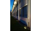 Facade lighting with GIFAS VisuLED - stylish and energy-efficient LED lighting on the Jura company building at night.