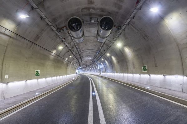 Road tunnel with continuous LED tunnel lighting on walls and ceiling for safe traffic routing and good visibility