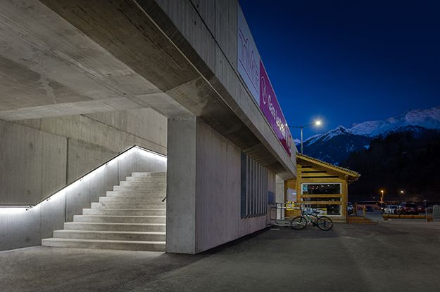 Illuminated external staircase at the station building with integrated LED handrail lighting - safe route guidance at dusk