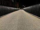 LaneLED light strip illuminates a slightly curved pedestrian path on a bridge and ensures clear orientation and safety at night