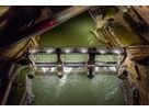 Aerial view of a dam at night with integrated LED lighting on weir and bridge structures