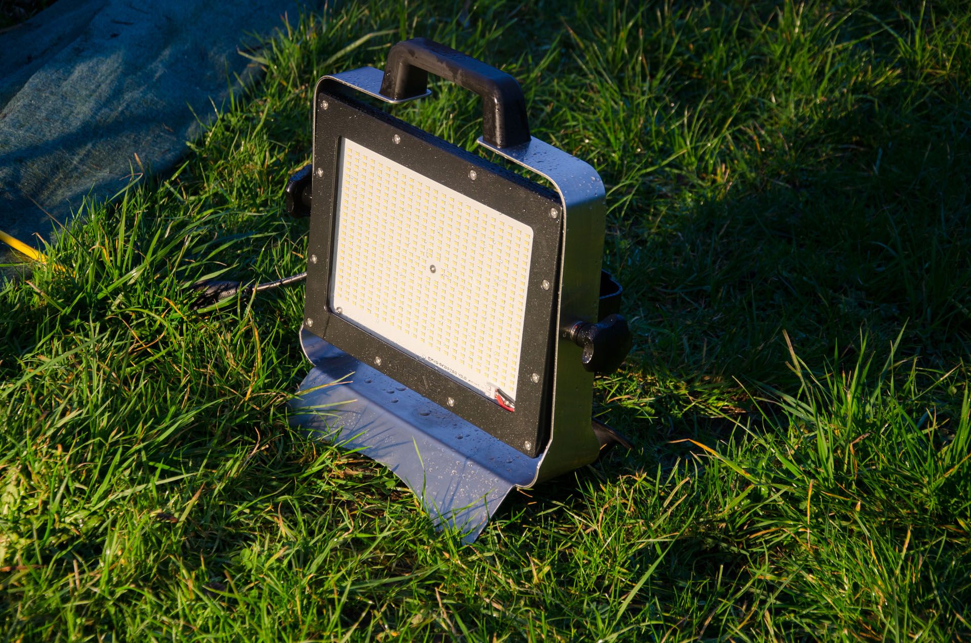 AlphaLUXX mobile LED spotlight on the ground for outdoor use for temporary lighting