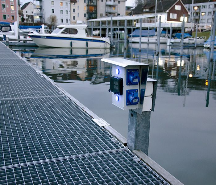 Energy column on the jetty in the harbor for supplying power to boats and yachts in the shipping industry