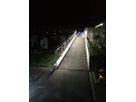 Illuminated path with LED handrail lighting at night at Glis cemetery