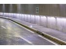 Tunnel routier avec éclairage LED le long du mur et voie de maintenance et d'évacuation éclairée pour une sécurité accrue