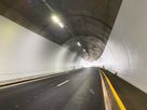 Well-lit road tunnel with LED ceiling lighting for clear visibility and safe traffic guidance along the roadway